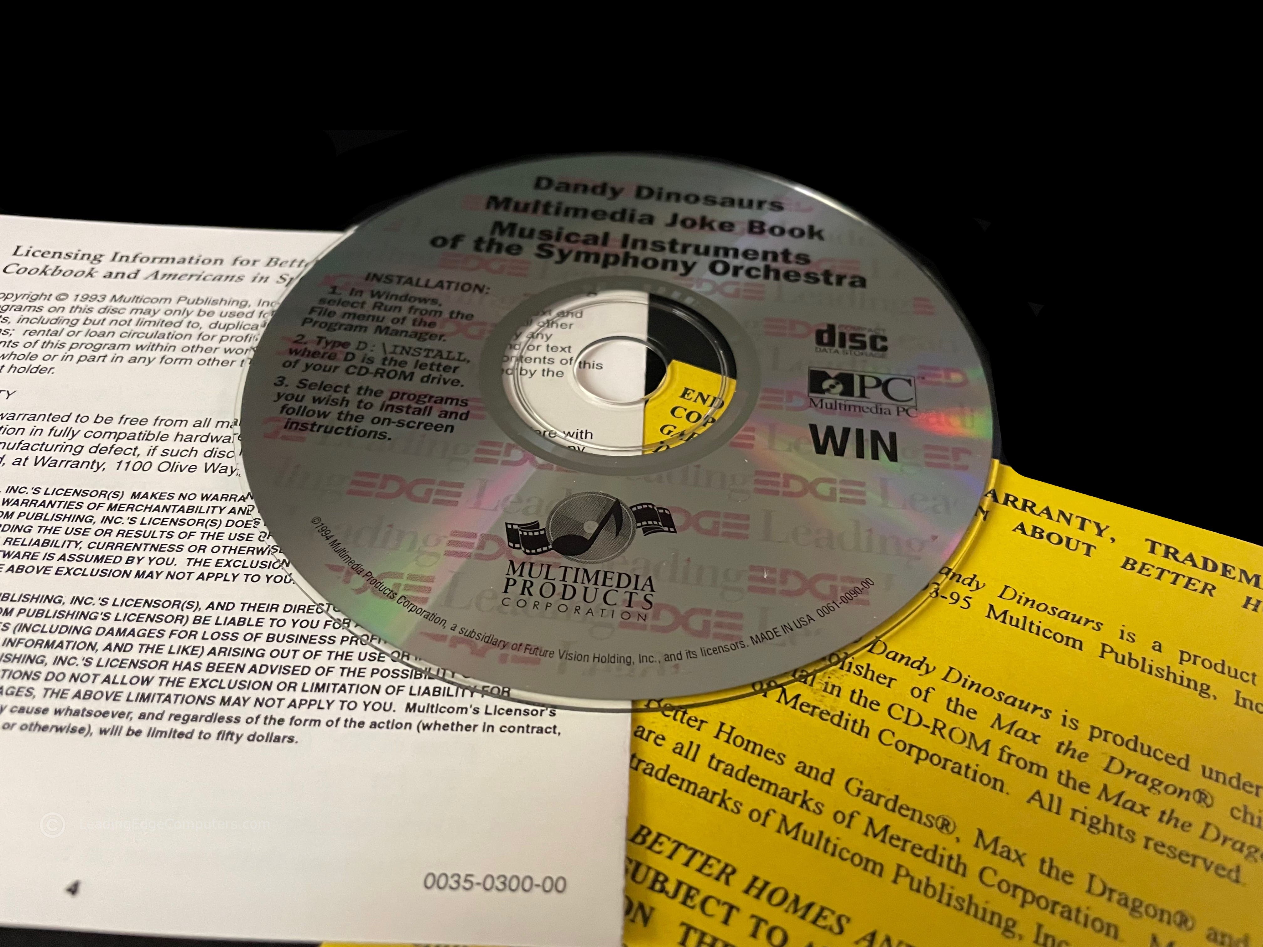 CD-ROM labeled with Leading Edge branding with Dandy Dinosaurs, Multimedia Joke Book, and Musical Instruments of the Symphony Orchestra