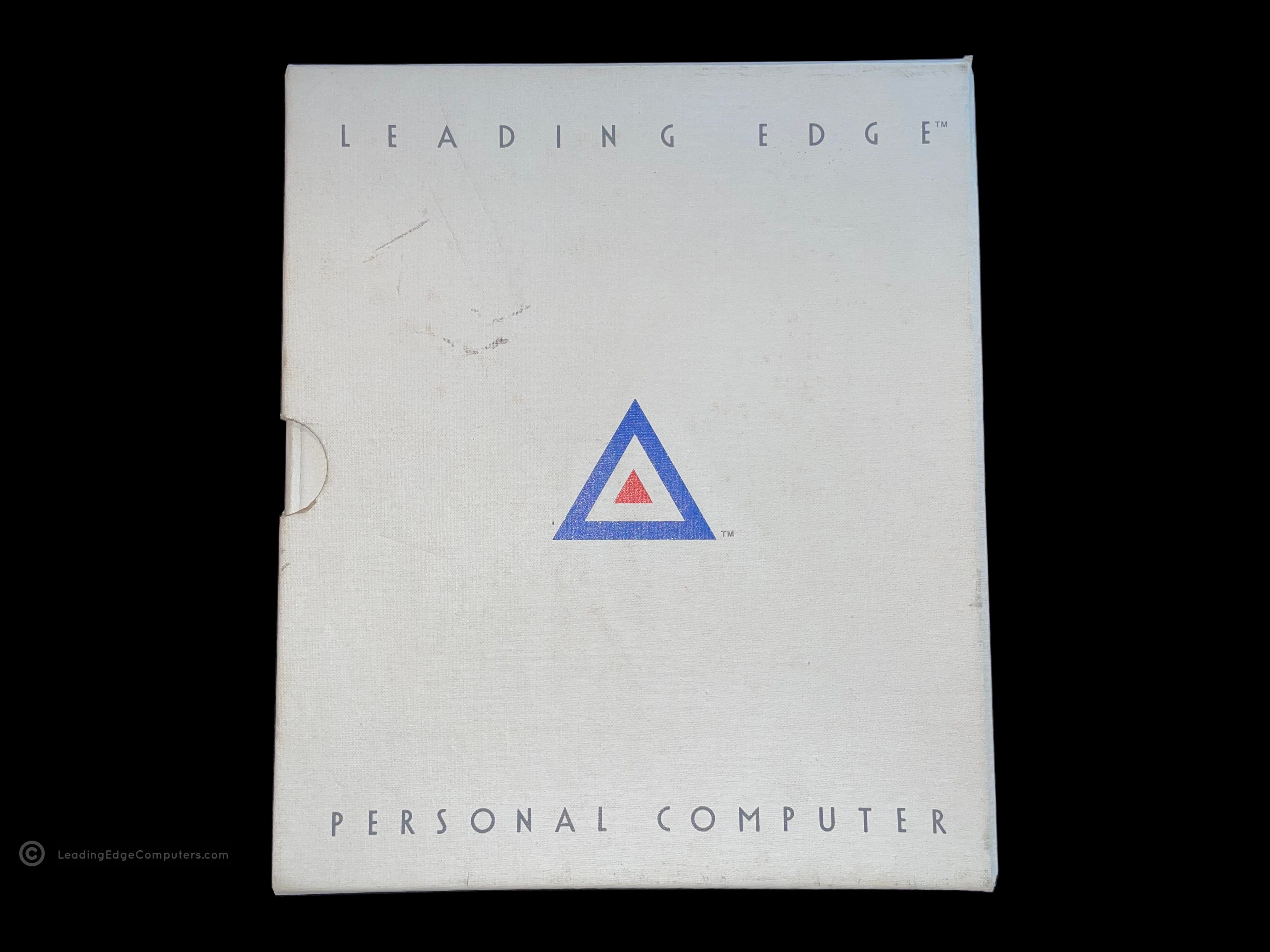 A photo of the Leading Edge Operator's Guide Technical Reference Manual in its sleeve