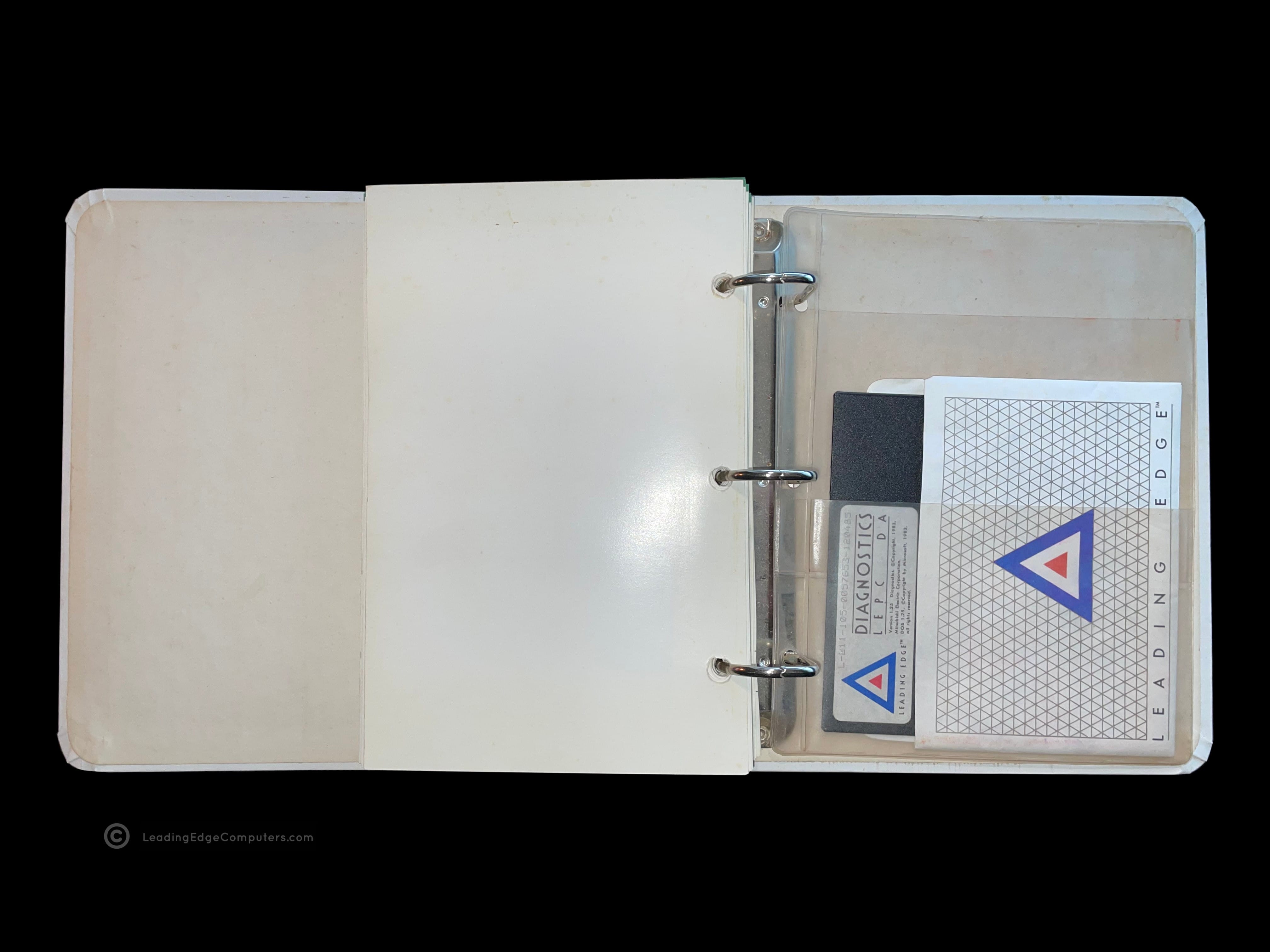 A photo of the back of an opened Leading Edge Operator's Guide Technical Reference Manual showing the plastic sleeve for housing the diagnostics disk