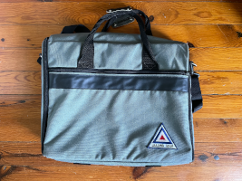 a grey colored laptop bag with a large leading edge logo sewn onto the lower right part of the bag