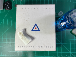 a photo of a Leading Edge operators guide technical reference manual that has sat on a shelf for decades, accumulating dust and dirt